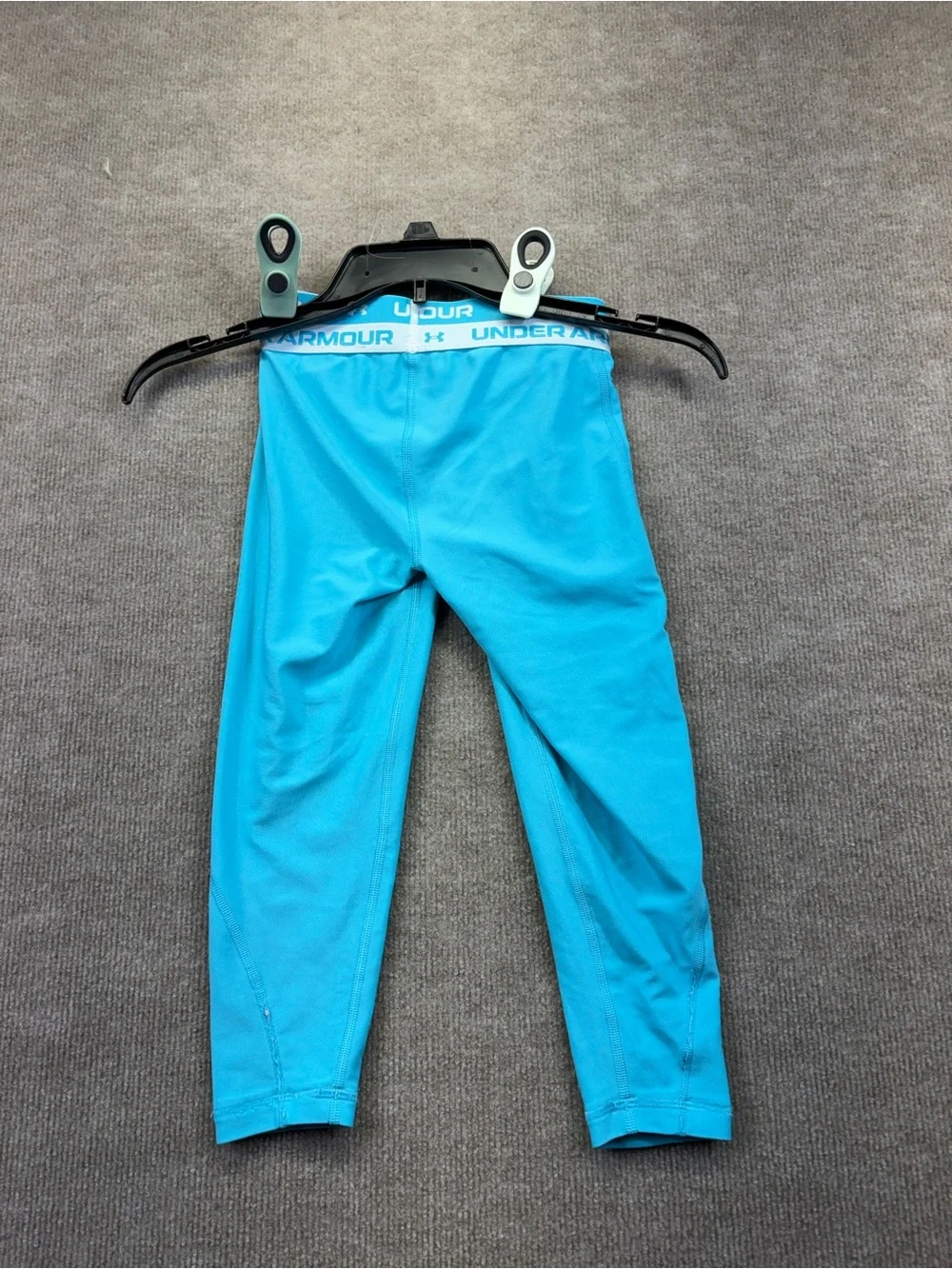 Under Armour YS are a teal blue with a logo elastic waistband